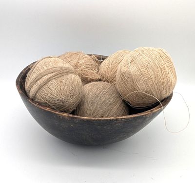 balls of yarn in a bowl on a table