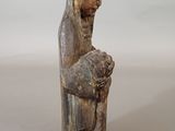 an old wooden statue of a woman holding a baby