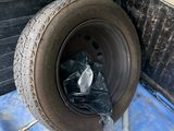 a tire that is sitting in the back of a truck