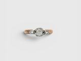 a close up of a diamond ring on a white surface