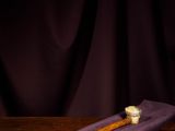 a glass of wine and a baseball bat on a table