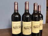 three bottles of wine sitting on top of a table next to each other