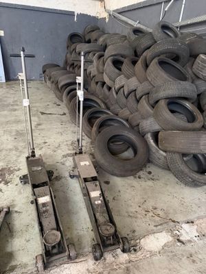 a pile of tires sitting on the floor in a warehouse