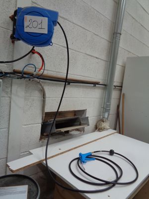 a refrigerator and a freezer in a room with a lot of wires