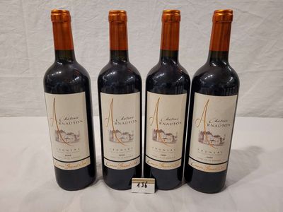 three bottles of wine are lined up on a table