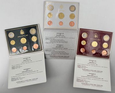 three different types of coins are in a display case