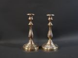 pair of antique brass candlesticks on a black background