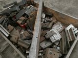 a wooden box full of metal parts on the ground
