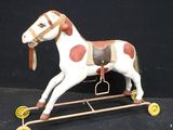 a toy horse that is sitting on a metal stand