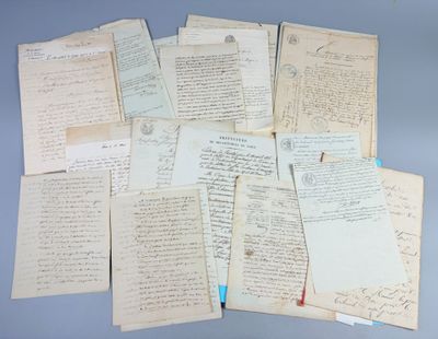 several old papers are stacked on top of each other on a table