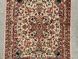 an antique persian rug with a floral design and fringes