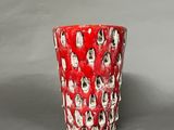 a red cup with skulls on it sitting on a table