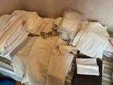 a bed that has a lot of clothes on top of it