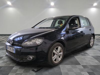 the black volkswagen golf is parked on a checkered tile floor