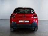 the rear end of a red citrole parked in a white room