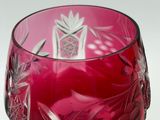 a red wine glass with a flower design on it