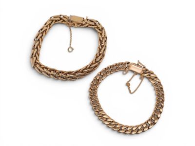 two gold bracelets on a white background
