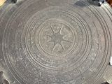 a large metal plate sitting on top of a wooden table