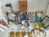many different clocks and other items on the table