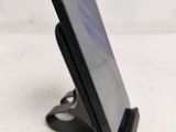 a cell phone that is on a stand on a table