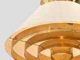 a white and gold lamp hanging from the ceiling