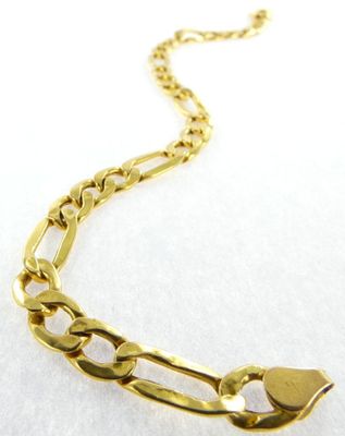 a close up of a gold chain bracelet on a white surface
