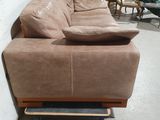 a couch that is sitting on a skateboard in a room