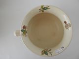 a white cup with a design on it on a table