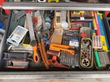 many different tools in a metal box on the table