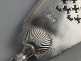 a silver spoon with a star design on it
