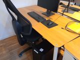 a computer desk with two monitors and a keyboard on it