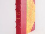 a red book with a yellow cover on a white surface