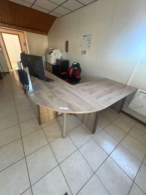 a table with a computer on it in a room