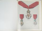 an open book with a picture of a medal on it