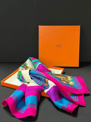 a pink, blue and green scarf and a orange box