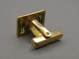 a close up of a pair of gold cufflinks on a table