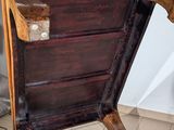 a wooden chair that is sitting on a tile floor