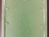 an old green book with a sticker on it sitting on top of a table