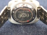 a close up of a wrist watch on a blue surface
