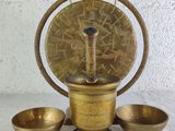 an antique brass mortar set with three bowls and a wooden stand