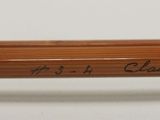 a close up of a pencil with writing on it sitting on a table