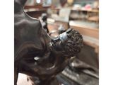 bronze statue of a man holding a woman in his arms
