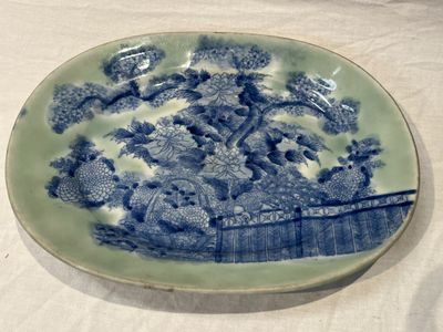 a blue and white plate with flowers on it