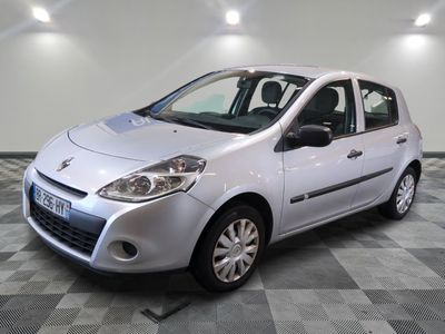 a picture of a small silver car parked in a garage