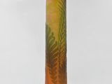 orange and green glass vase with a tree design on the base