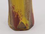 a glass vase with a yellow and red design on it