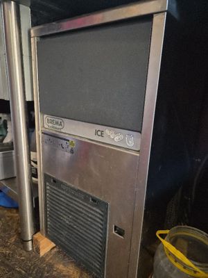 a tv on top of an ice machine in the kitchen