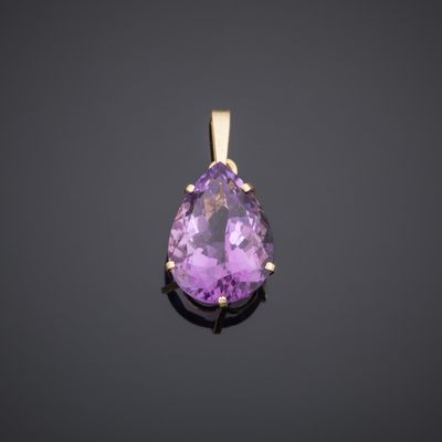 an amethorate and diamond pendant on a black background