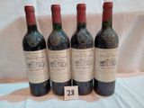 three bottles of red wine are lined up on a table