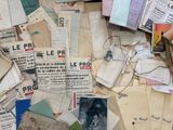 a pile of old papers and papers on a table